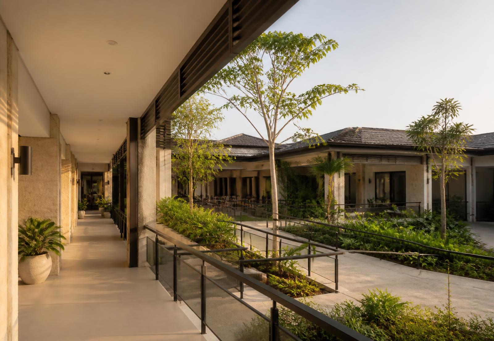 Accessible landscaped courtyard and shaded walkway in a low-rise senior living development